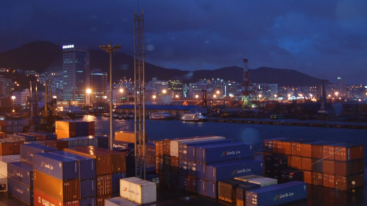 Stacked containers at a Busan port container yard at dusk