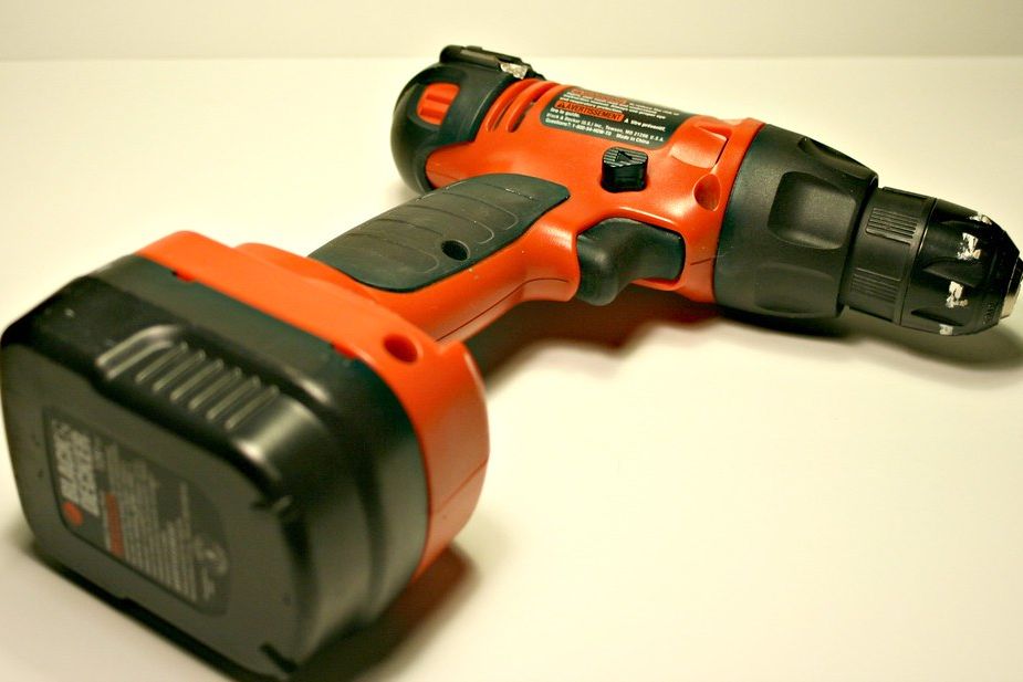 A cordless drill with its battery pack attached