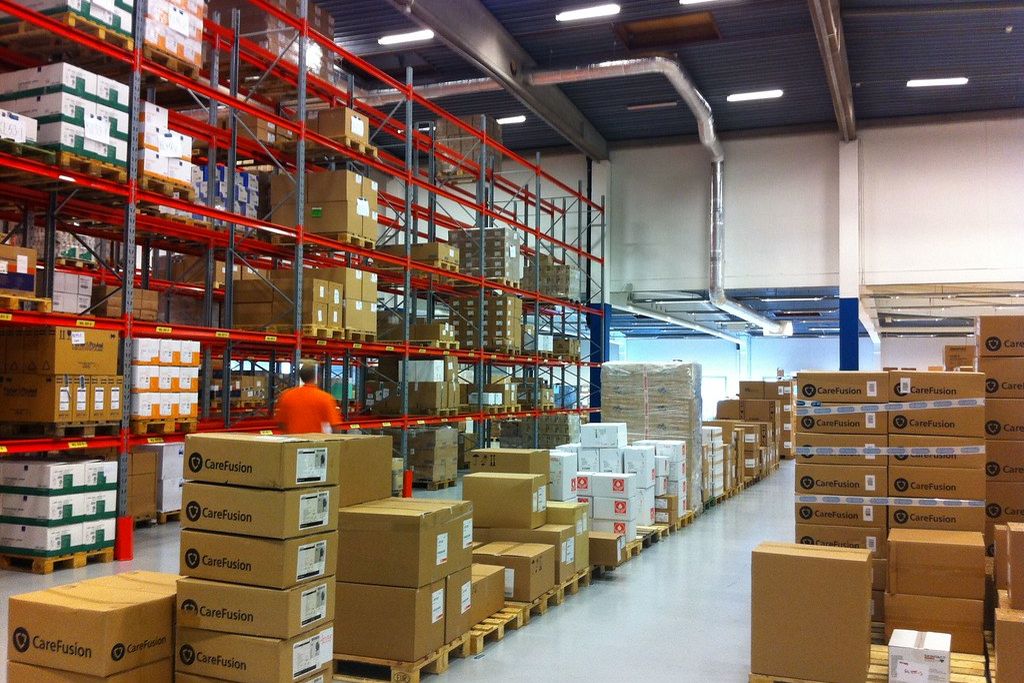 Warehouse with red racking and pallets of boxes